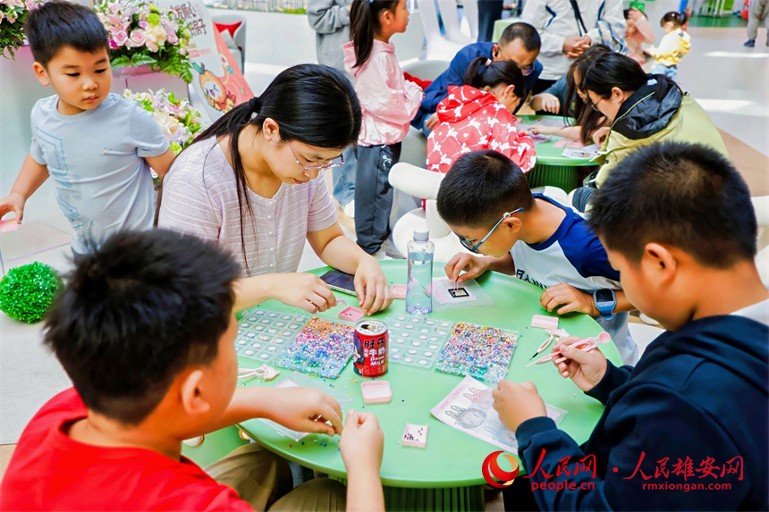 国庆假期,在雄安新区启动区,家长带孩子参加游戏。人民网记者 王红摄